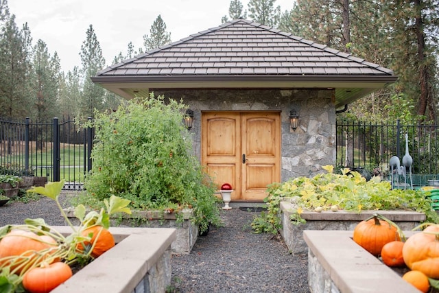 view of outbuilding featuring fence