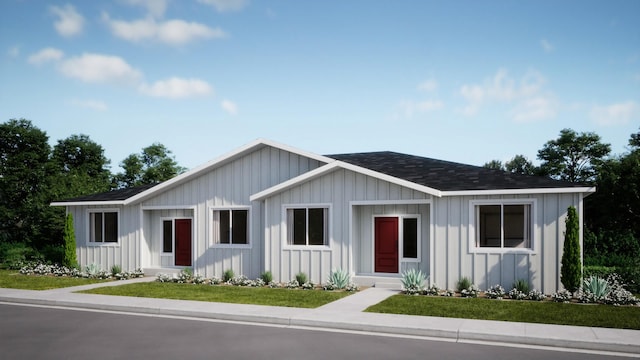 single story home with entry steps, a shingled roof, a front lawn, and board and batten siding