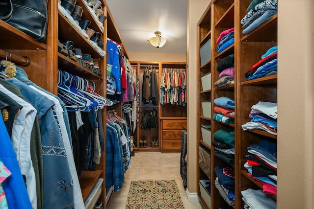 spacious closet with light tile patterned floors