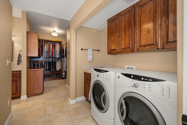 washroom featuring light tile patterned floors, baseboards, and washer and dryer