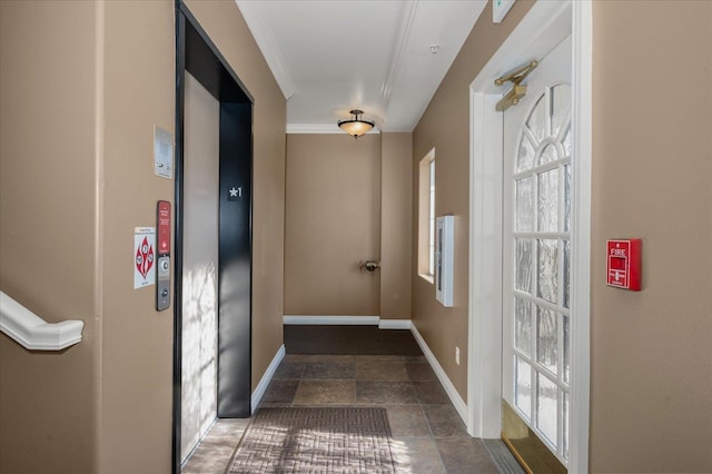 doorway featuring elevator and baseboards