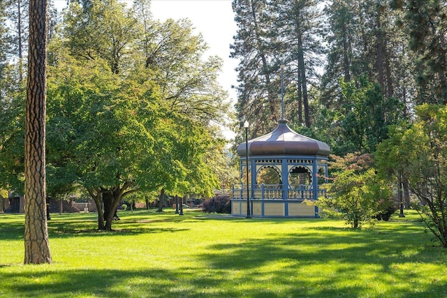 view of property's community with a yard and a gazebo