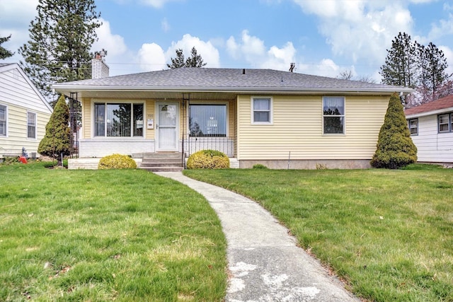 view of front of property with a front lawn and a chimney