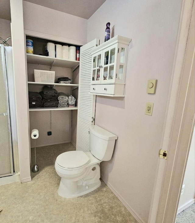 full bath with baseboards, toilet, and walk in shower