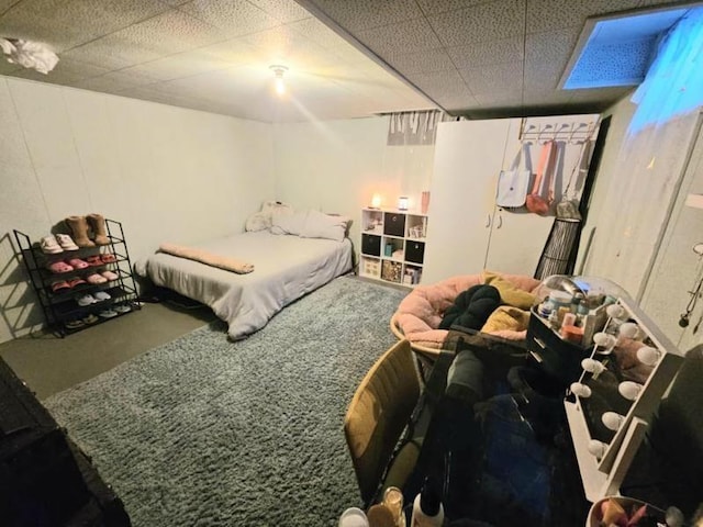 bedroom with carpet and a drop ceiling