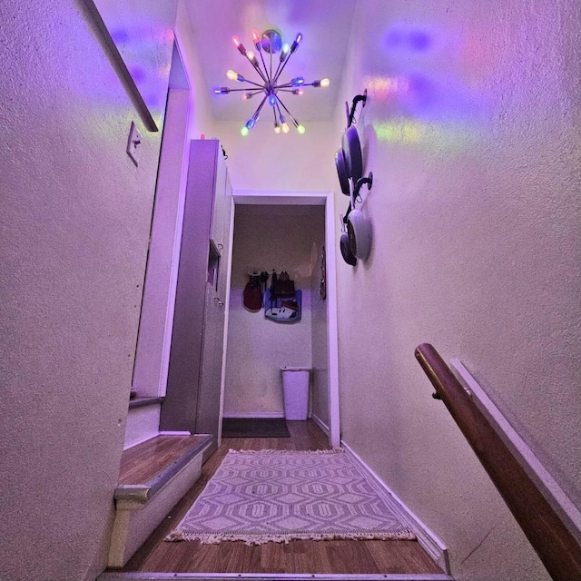 stairway with baseboards and wood finished floors