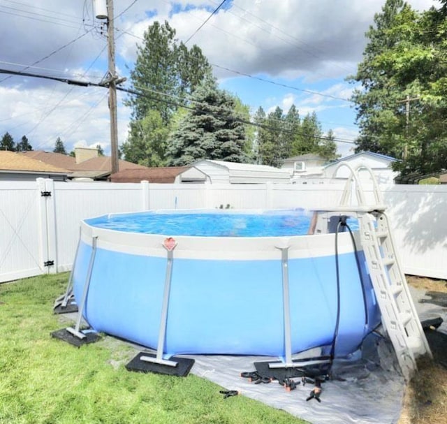 view of swimming pool with a yard, a gate, a fenced backyard, and a fenced in pool