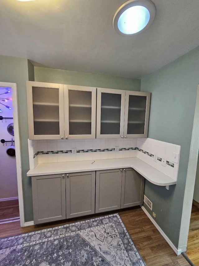 328 W Nebraska Ave, Spokane, WA 99205 - kitchen featuring gray cabinetry, dark wood-style floors, tasteful backsplash, and baseboards