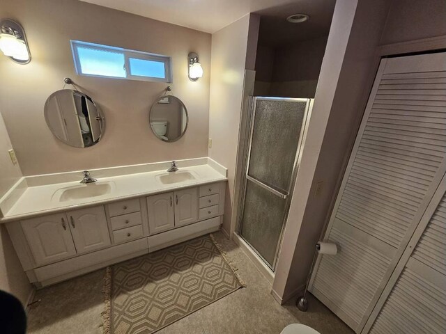 328 W Nebraska Ave, Spokane, WA 99205 - bathroom featuring double vanity, a shower stall, and a closet
