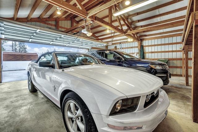 garage featuring metal wall and a garage door opener