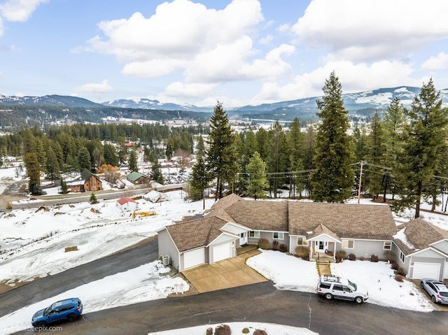 snowy aerial view with a mountain view