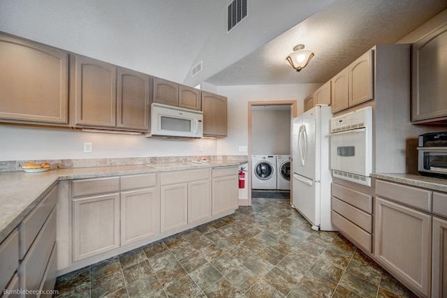 kitchen with light countertops, white appliances, independent washer and dryer, and visible vents