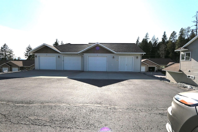 single story home with a shingled roof