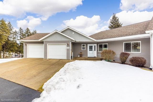 ranch-style house with driveway, roof with shingles, and an attached garage