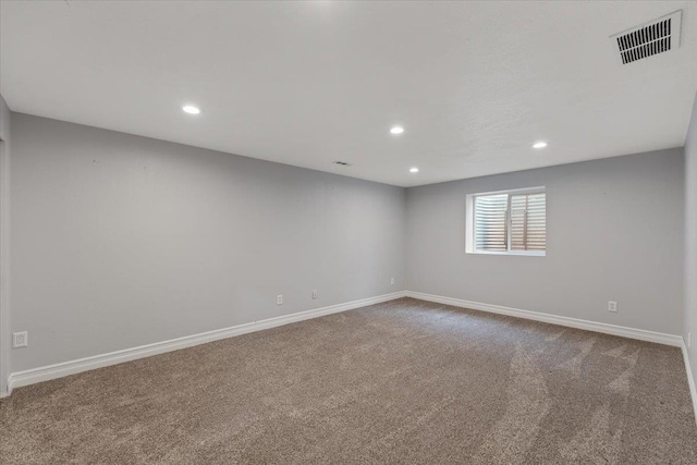 spare room featuring baseboards, visible vents, carpet flooring, and recessed lighting