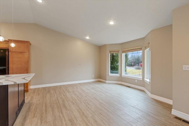 unfurnished living room featuring light wood-style floors, lofted ceiling, baseboards, and recessed lighting