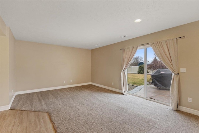 spare room with recessed lighting, visible vents, carpet flooring, a textured ceiling, and baseboards