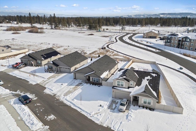 snowy aerial view with a residential view