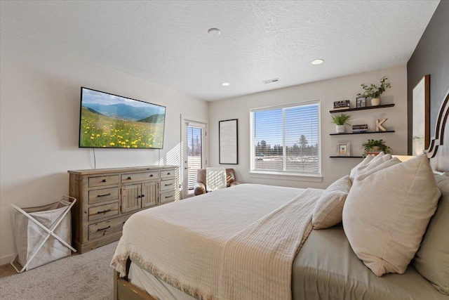 bedroom featuring recessed lighting, visible vents, a textured ceiling, and light colored carpet