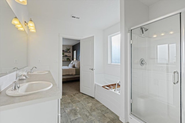 ensuite bathroom featuring a shower stall, visible vents, a sink, and ensuite bathroom