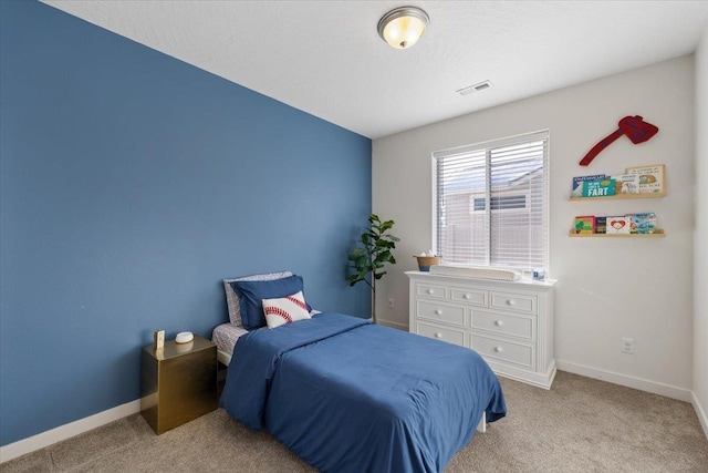 bedroom featuring visible vents, baseboards, and light colored carpet