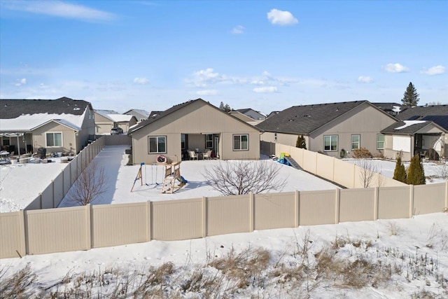 exterior space with a residential view and a fenced backyard