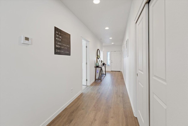 corridor with recessed lighting, light wood-style flooring, and baseboards