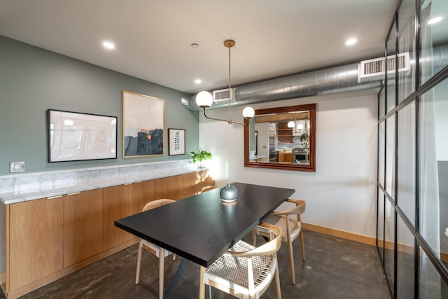 dining room featuring finished concrete flooring, baseboards, visible vents, and recessed lighting