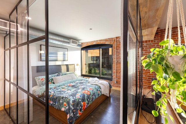 bedroom featuring finished concrete flooring and brick wall