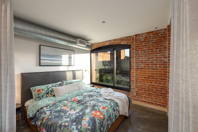 bedroom with brick wall and baseboards