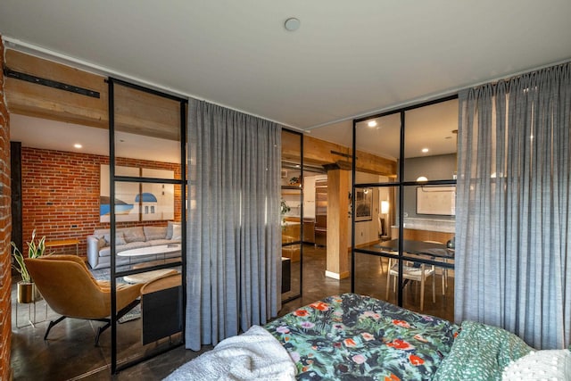 bedroom featuring brick wall