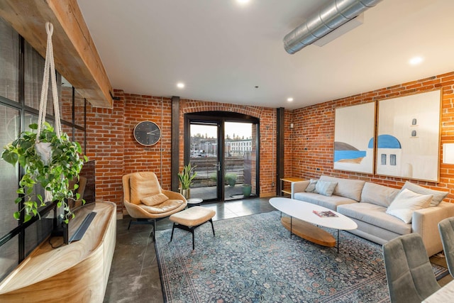 living room with recessed lighting and brick wall