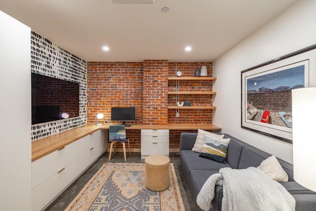 office space featuring brick wall, built in study area, and recessed lighting