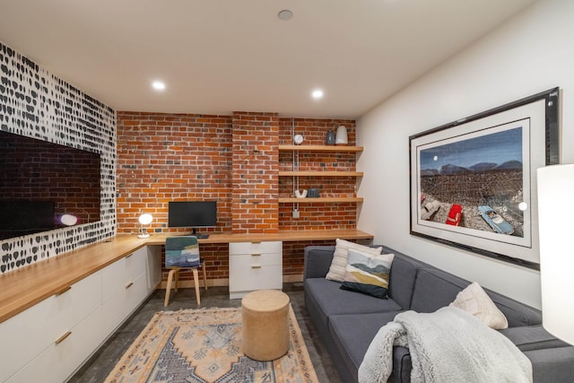 office space featuring brick wall, built in study area, and recessed lighting