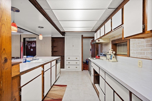 kitchen featuring white appliances, white cabinets, hanging light fixtures, light countertops, and light floors