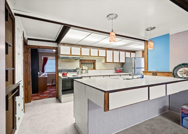 kitchen featuring light countertops, freestanding refrigerator, decorative light fixtures, and white range with electric cooktop