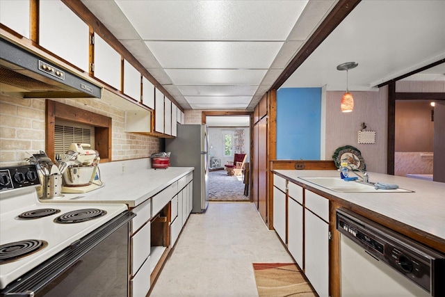 kitchen with light countertops, pendant lighting, white cabinets, and electric range oven