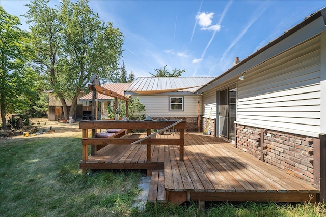 wooden terrace featuring a yard