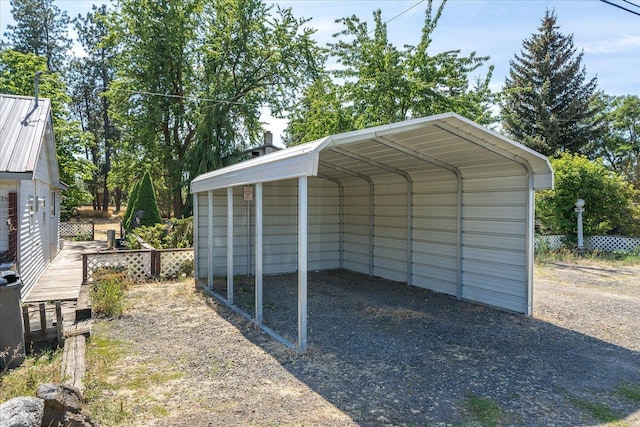 view of car parking with a carport, fence, and driveway