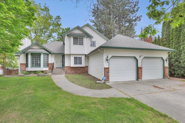 1107 E Chantel Dr, Spokane, WA 99218 - view of front of home featuring a garage, brick siding, driveway, a front yard, and a shingled roof