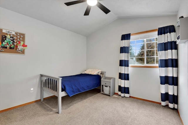 bedroom with a ceiling fan, lofted ceiling, carpet flooring, and baseboards