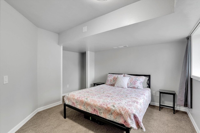 bedroom featuring visible vents, baseboards, and light colored carpet