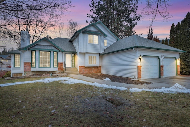 view of front of house featuring a shingled roof, concrete driveway, a chimney, an attached garage, and brick siding