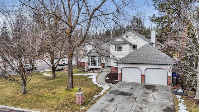 traditional-style house with an attached garage, brick siding, a shingled roof, concrete driveway, and a front yard