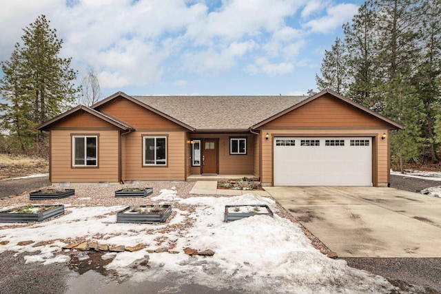 view of front facade with a garage, driveway, and a shingled roof