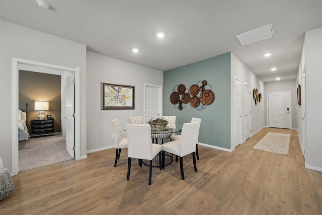 dining room featuring light wood finished floors, recessed lighting, visible vents, and baseboards