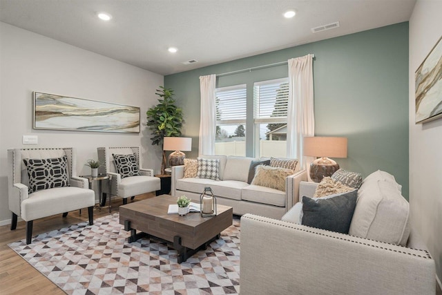 living area featuring recessed lighting, visible vents, and light wood-style flooring