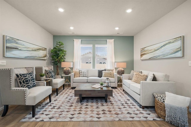 living area featuring light wood-type flooring, visible vents, and recessed lighting