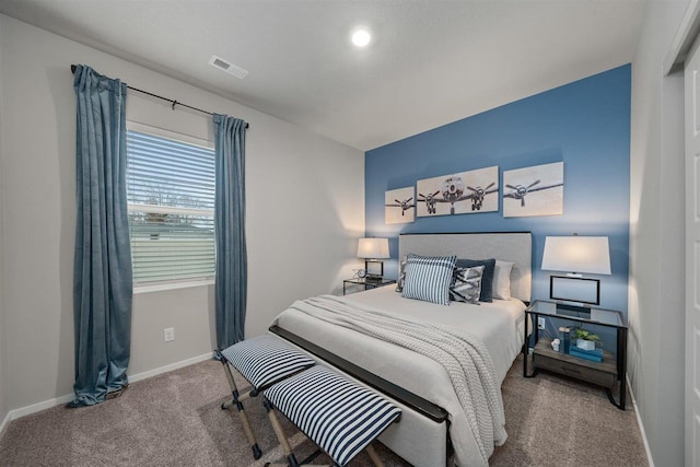 carpeted bedroom with baseboards and visible vents