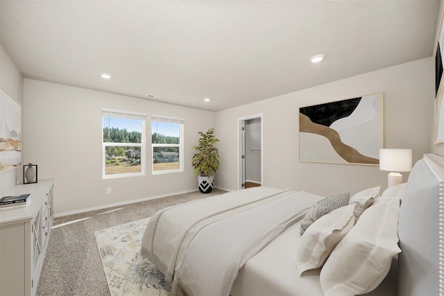 bedroom with baseboards, a textured ceiling, recessed lighting, and light colored carpet